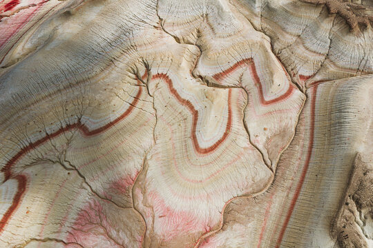 Aerial view of the colorful striped rock formations of Kyzyl Kup, also known as Tiramisu, featuring intricate geological layers and patterns, Karakiya District, Mangystau Region, Kazakhstan.