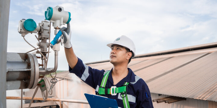 Professional engineer checklist monitor industrial air pollution reduction in industrial plant. Engineering Asian working analysis environment protection digital scene for sustainable energy. ESG