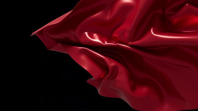 Beautiful scarlet satin material flowing gently against dark empty space