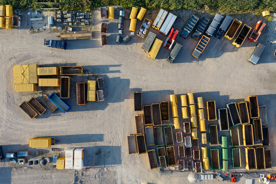 Aerial view of the GP Groot collection and recycling facility with rows of colorful waste containers and dumpsters arranged on a gravel yard in Alkmaar, Noord-Holland, Netherlands.