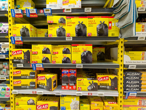 Quebec, Canada, 16 May 2026 : Various brands of garbage bags and household products are displayed on shelves in a supermarket aisle.