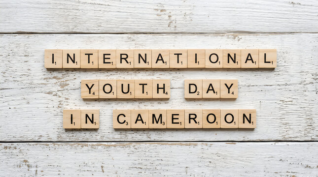 International youth day in cameroon spelled with wooden scrabble tiles on a rustic white wooden background