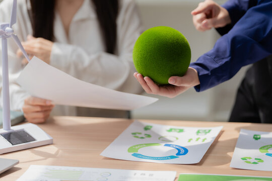 Close up of business team planning clean energy and ESG sustainability campaign in office meeting.