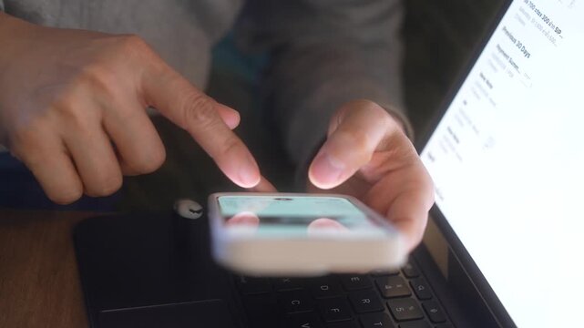 Smartphone And Laptop Technology, Close Up Hands Scrolling Mobile Screen And Pointing At Computer Display, Online Research, Digital Comparison, Business Analysis And Multitasking Workflow.