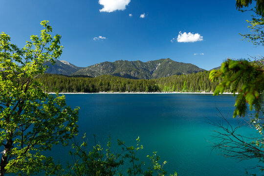Travel landscape of Eibsee lake and  mountain peak in Alps in Bavaria,  Germany, scenic summer nature panorama with forest und mountains. Alpine landscape