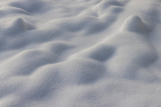 details a lot of snowdrifts of white color, soft and fluffy freshly fallen snow in the winter season in sunny weather, the structure of snow after a snowfall