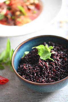 Close-up of cooked black rice, colorful healthy food background, detailed view of glossy rice grains, nutritious ingredient, healthy diet, wholesome meal and modern food photography