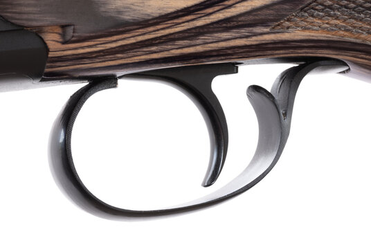 Angled view of the trigger on a wood-stocked shotgun