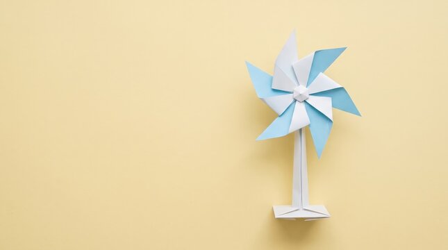 Colorful Paper Windmill Toy on Yellow Background for Playful and Creative Imagery