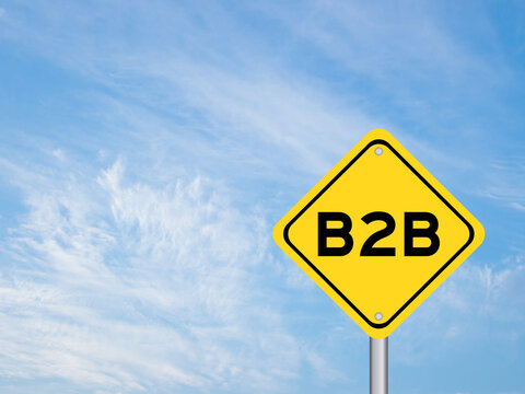 Yellow transportation sign with word b2b (abbreviation of business to business) on blue color sky background