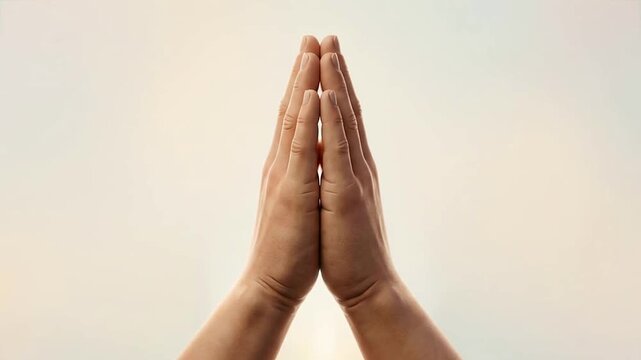 Close-up of Hands in Prayer Position with Soft Light Background