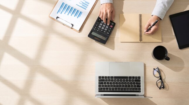 Professional accountant working at desk. Financial analyst calculating data in notebook.