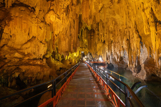 Illuminated limestone cave with spectacular stalactites and underground walkway at Tham Pla Chuem Cave, Thakhek, Laos