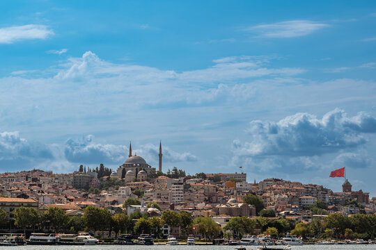 Istanbul, turkey, august 2, 2025 istanbul, turkey cityscape from the golden horn, featuring traditional architecture, the yavuz sultan selim mosque, and a flying turkish flag