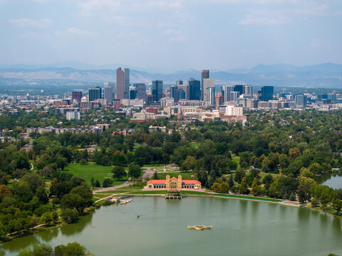 Aerial view of City Park and Ferril Lake with the Denver skyline in the background under a clear blue sky in Denver, Colorado, United States.