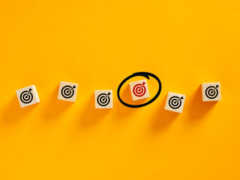 Choosing right target among many targets for business objective on yellow background