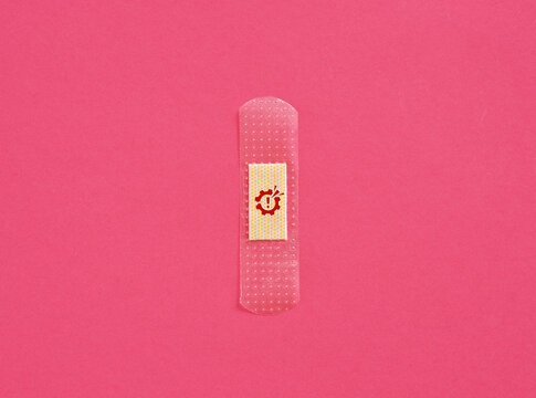 Adhesive Bandage with Gear and Exclamation Mark Symbol on Pink Background
