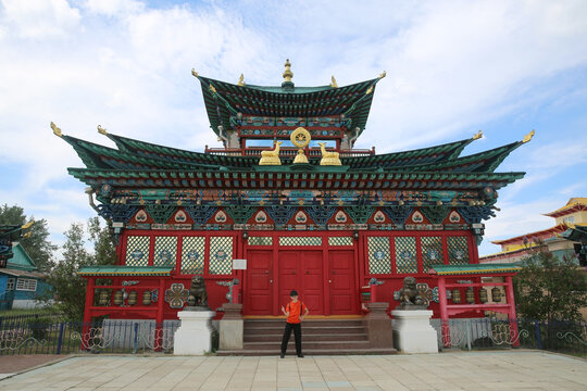 Historical monument Ivolginsky datsan "Khambyn Khuree", buddist temple, landmark, sight. Tourist child, kid, cute boy in Buryat traditional national costume, hat