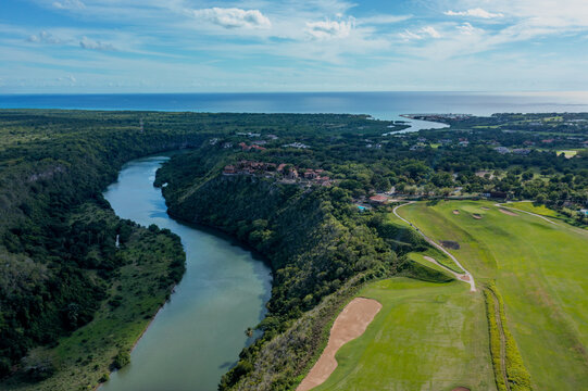 Aerial view of Altos de Chavon village perched on a cliff overlooking the Chavon River and a lush golf course in La Romana, La Romana Province, Dominican Republic.