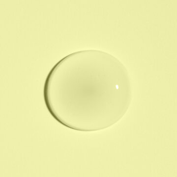 Cosmetic transparent product on a yellow background. A serum or gel or cream.