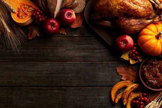 Thanksgiving Rustic Flat Lay with Roasted Turkey Pumpkin Apples Wheat and Copy Space on Dark Wooden Background