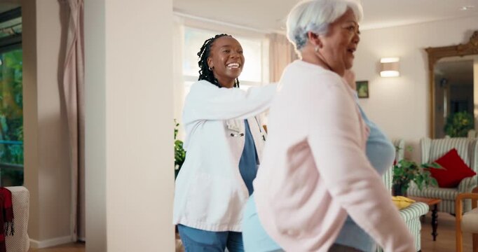 Happy, doctor and old woman dance in home for wellness, good news or recovery from medical condition. Flare, healthcare worker and senior person with celebration, healing and movement for fitness.