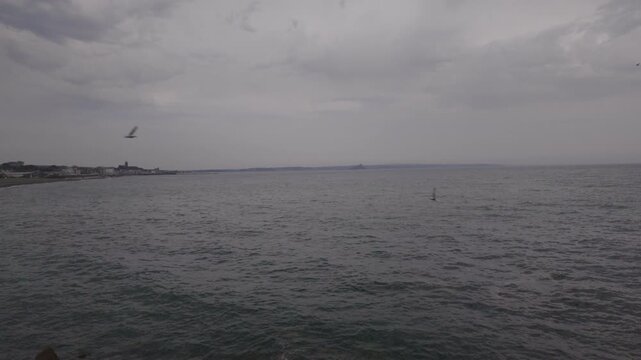 Views over Penzance seafront at high tide on a hot overcast June day.