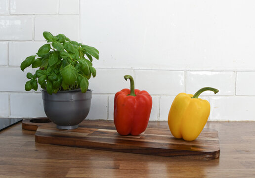 Fresh Vegetables and Fruit on a Chopping Board on a Kitchen Counter