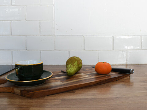 Fresh Vegetables and Fruit on a Chopping Board on a Kitchen Counter