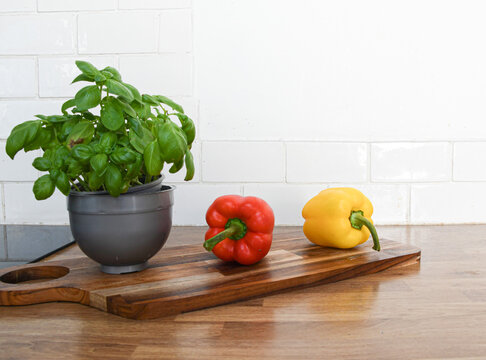 Fresh Vegetables and Fruit on a Chopping Board on a Kitchen Counter