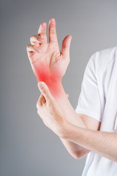 Close up of man massaging painful palm with red highlighted spot, smartphone thumb, trigger finger or carpal tunnel syndrome medical concept