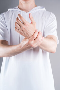 Unrecognizable man massaging pain wrist. Concept treatment sports injury, arthritis, gout and inflammation wrist joint in medicine