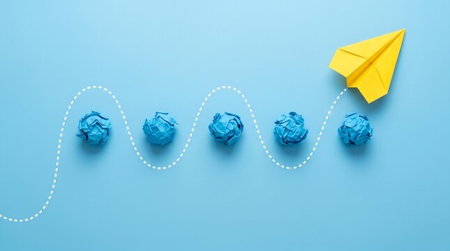 Yellow paper airplane leading blue crumpled paper balls along a dotted path on solid light blue background