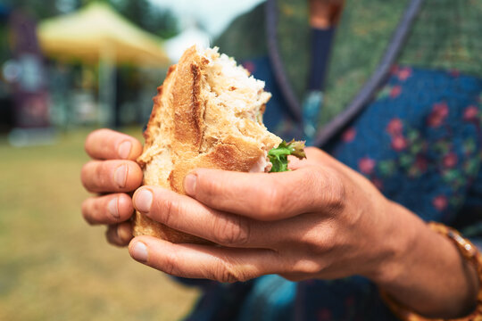 Close-up of a chicken ciabatta sandwich held in two hands