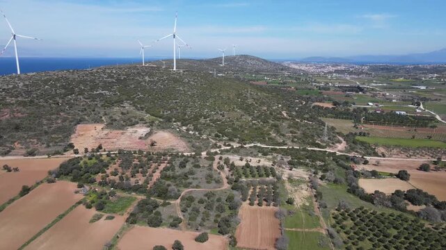 Aerial Drone View of Wind Turbines and Agricultural Fields with Aegean Coastline, Cesme Turkey