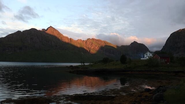 View of Lofoten, steeply rising mountain landscape above ocean in Norway