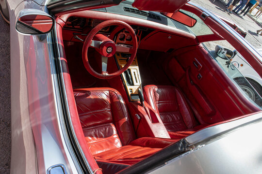 Tavernes Blanques, Spain - June 14, 2026. High angle view of red leather dashboard and seats in vintage Chevrolet Corvette sports car