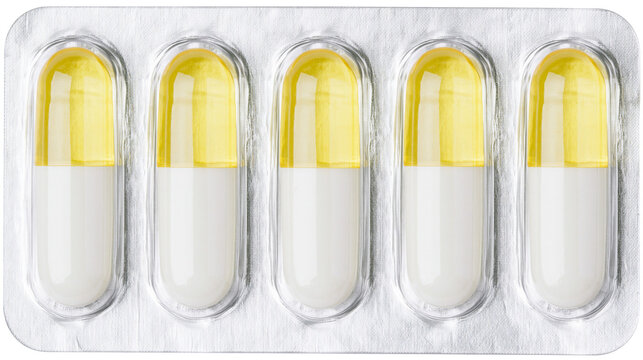 Five white and yellow capsules in a silver blister pack, isolated on transparent background