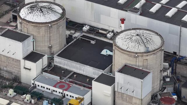 Aerial view of the CNPE de Fessenheim nuclear power plant with its two large reactor containment buildings and industrial structures in Fessenheim, Grand Est, France.