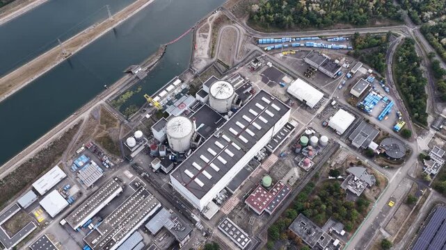 Aerial view of the CNPE de Fessenheim nuclear power plant featuring reactor domes, industrial facilities, and adjacent canal infrastructure in Fessenheim, Grand Est, France.