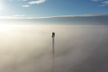 Obraz premium Network transmission tower in minimal foggy landscape