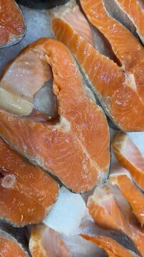Slices of fresh raw salmon with vibrant orange color arranged for seafood-themed backgrounds