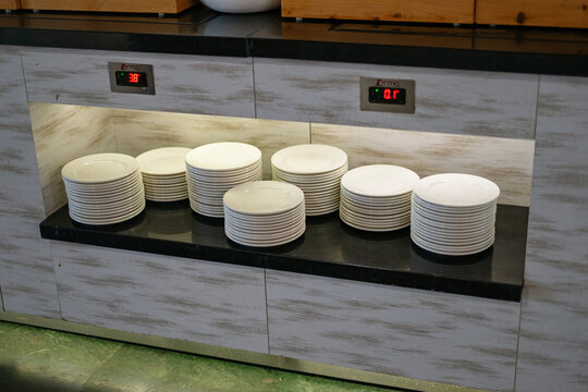 Stacks of white plates at hotel buffet restaurant in Turkey