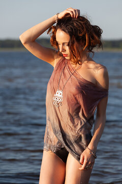 Nude Woman Standing In Water Wearing Translucent Shirt