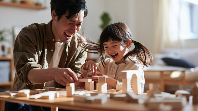 Father and Daughter Building Together: A heartwarming scene of a father and his young daughter sharing laughter and building a wooden block structure.