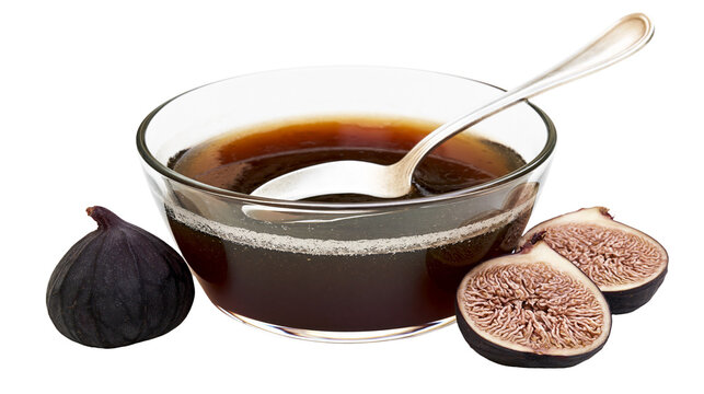 Dark purple figs and sweet syrup in a glass bowl with a spoon, isolated on transparent background