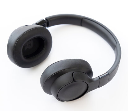 Modern wireless black headphones isolated on white background
