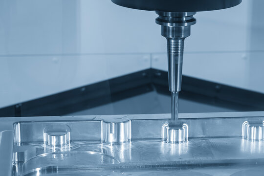 Flat nose end mill finishing cut on aluminum part with CNC milling machine in blue tone lighting