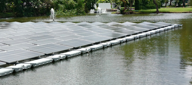 Floating Solar Panel System on Reservoir with Water Fountains and Green Park Landscape