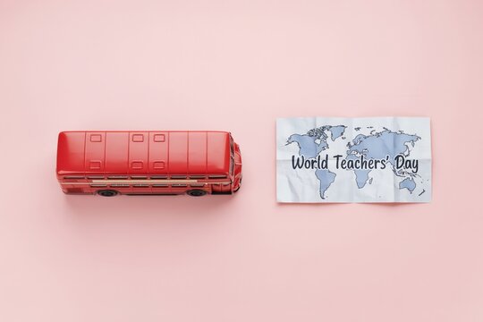 Red double-decker bus miniature beside a world map with text celebrating Teacher's Day, showcasing global appreciation for educators